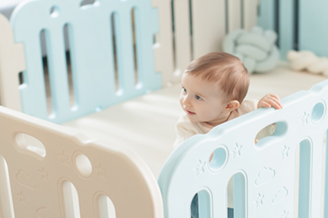 baby playing inside a playpen