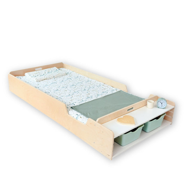 Twin bed with storage drawers and a clock on a white background