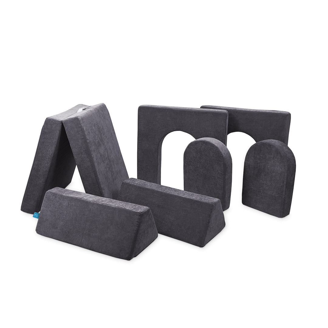 A set of seven gray modular foam pieces designed for creative play, with different shapes including arches and straight sections.