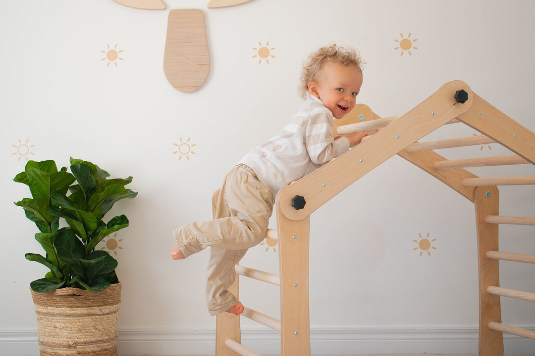 Toddler Climbing On A Pikler Triangle