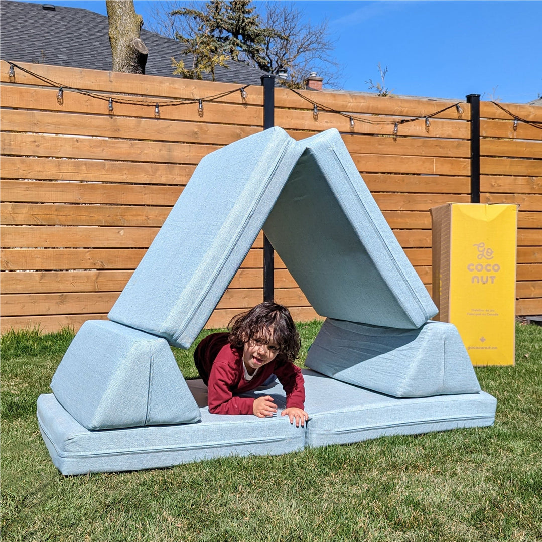 Kids jumping and playing with a orange play couch made in Canada