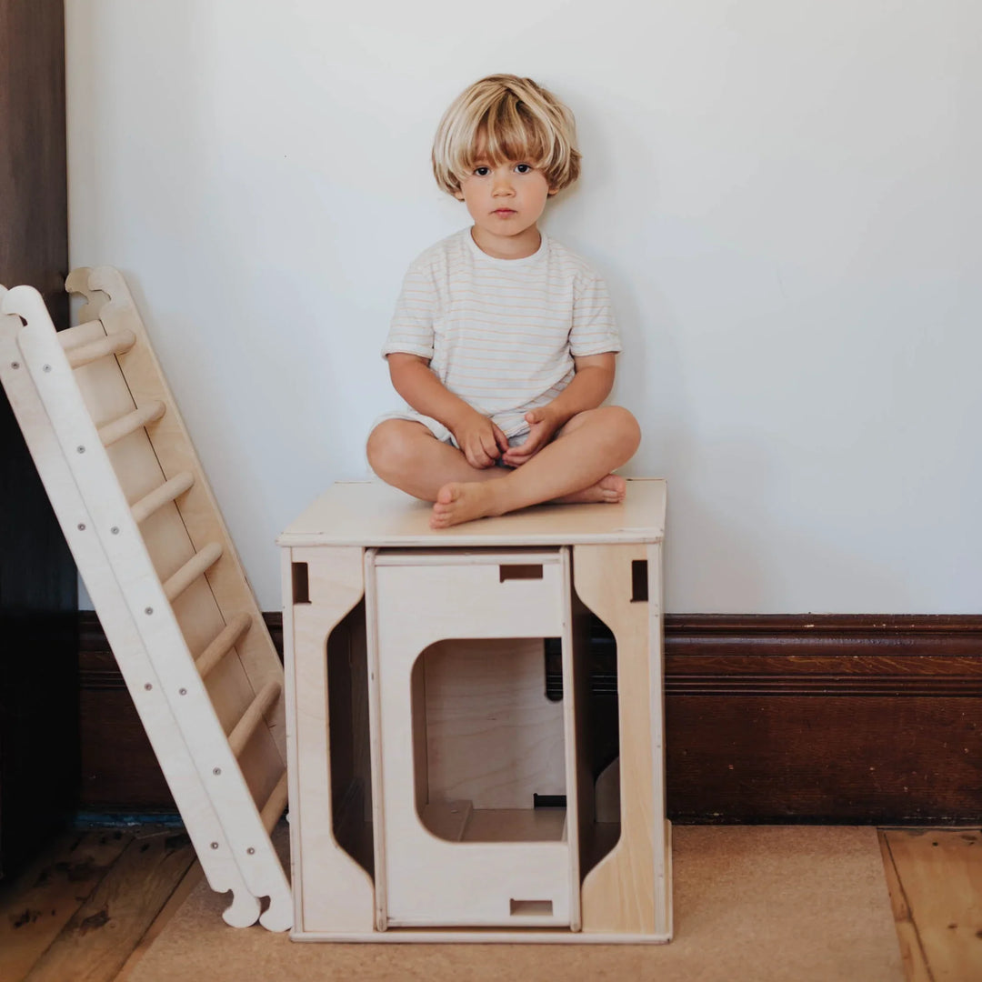 toddler playing with a wooden kid climber made in canada