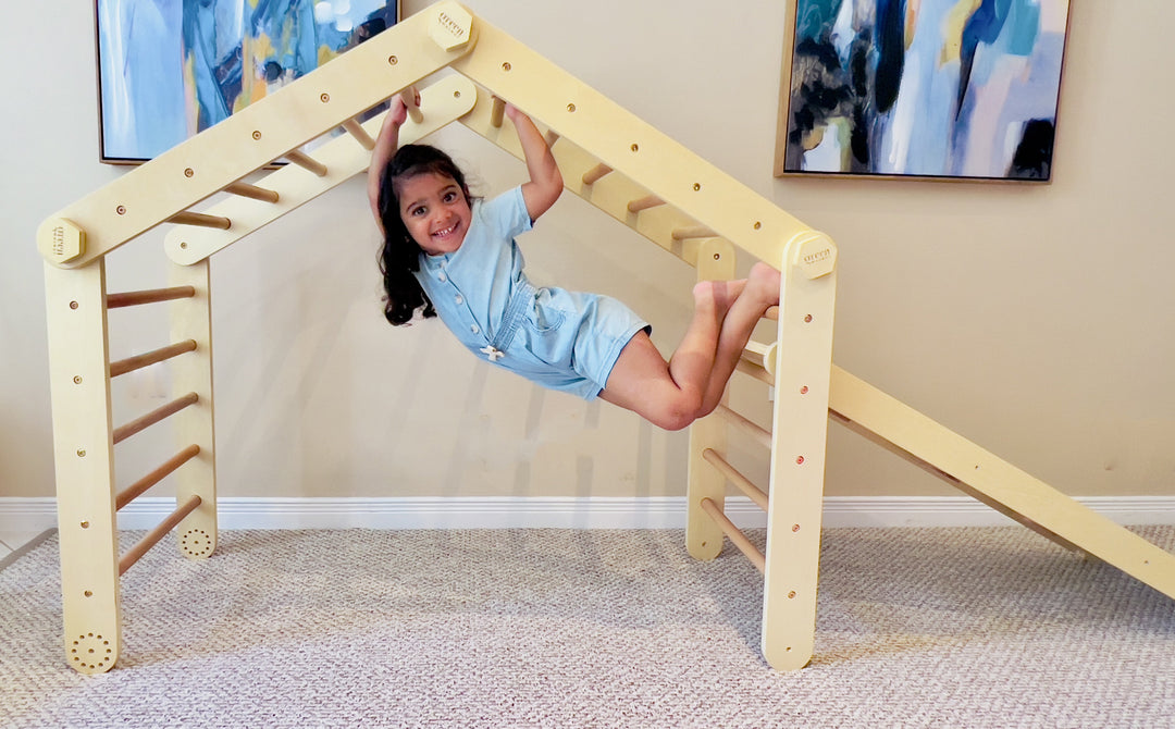 Toddler Playing With A Wooden Pikler Climbing Frame