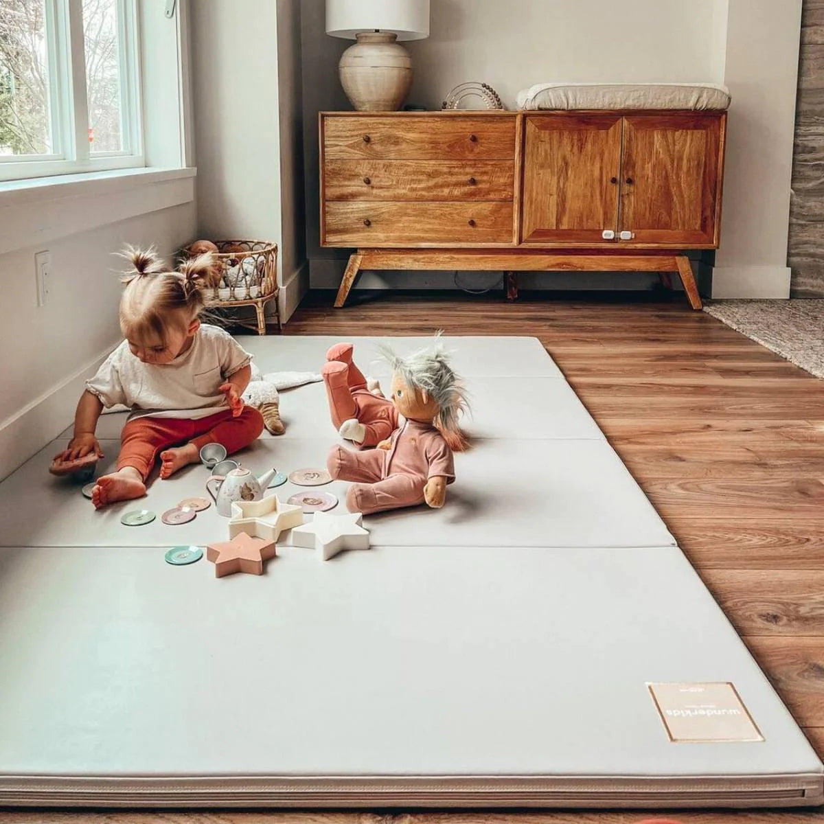 Toddler playing on a non toxic playmat