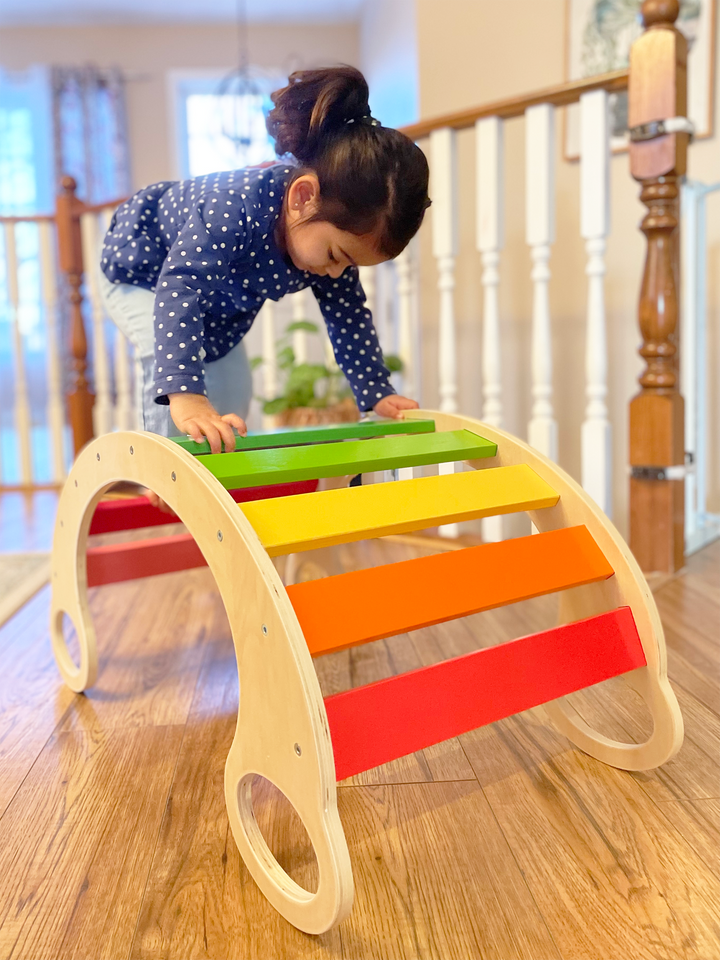 Kid Climbing On A Colorful Rocker Arcj