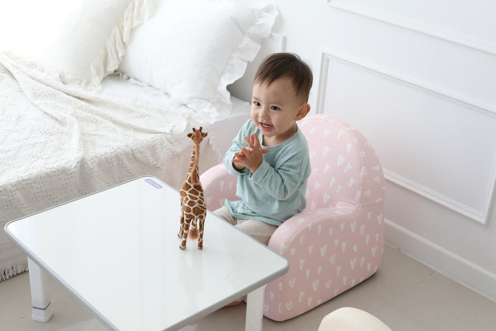 Toddler playing on the Baby Care Pink with Hearts kids sofa