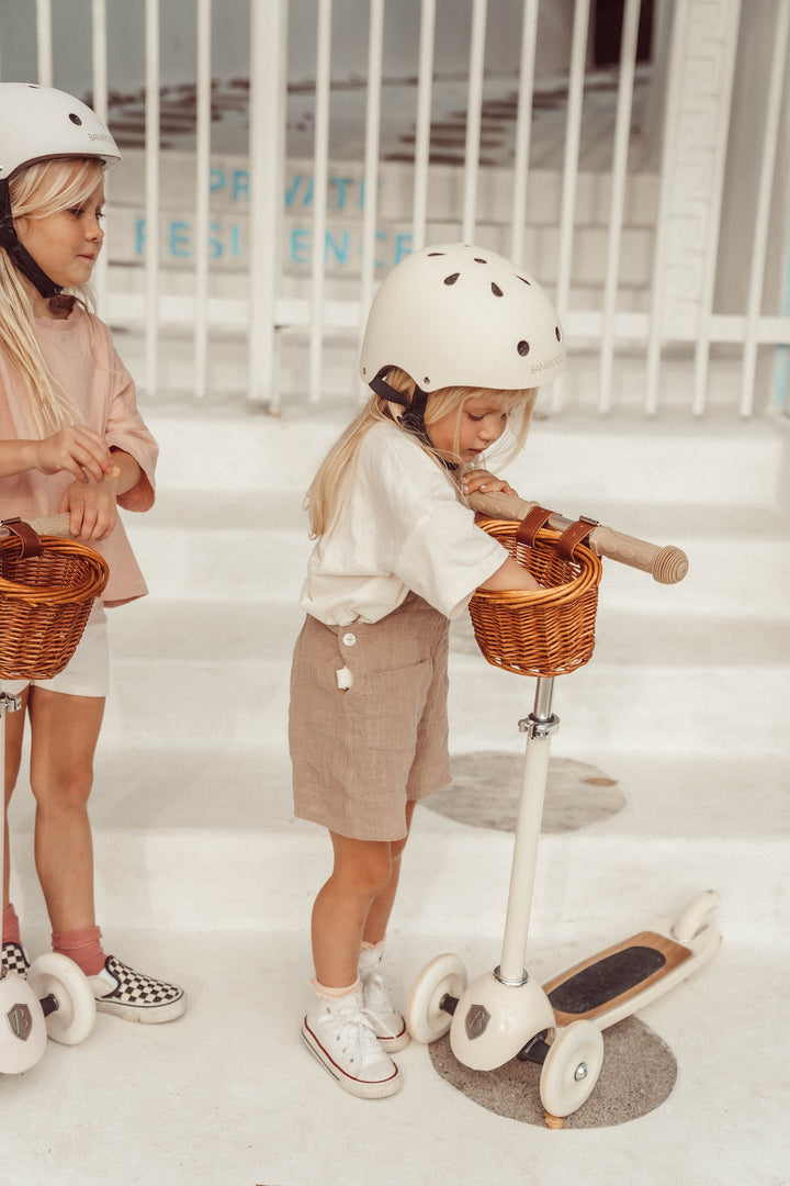 Two children in helmets with Banwood Vintage Scooters