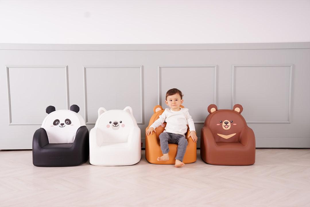 Toddler on the Dwinguler Grizzly Bear kids sofa next to the other Bear Friends