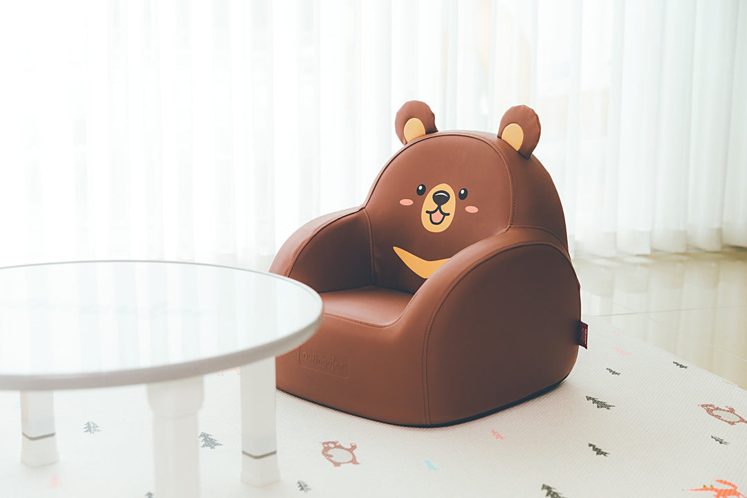 Dwinguler Moon Bear kids sofa beside a play table