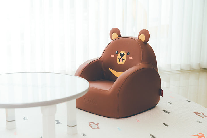Dwinguler Moon Bear kids sofa beside a play table