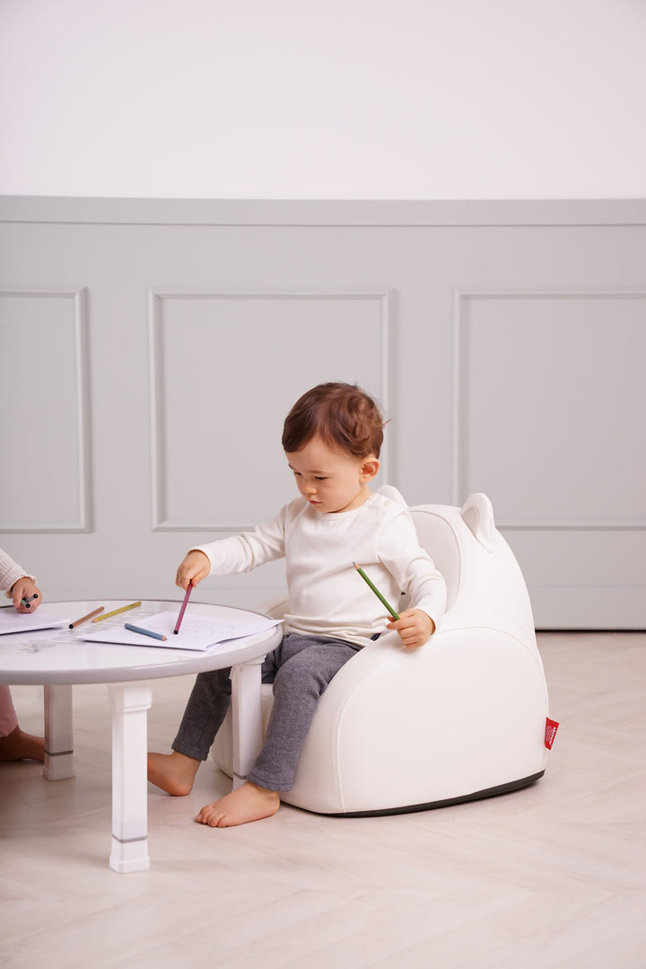Child drawing while sitting on the Dwinguler Polar Bear kids sofa