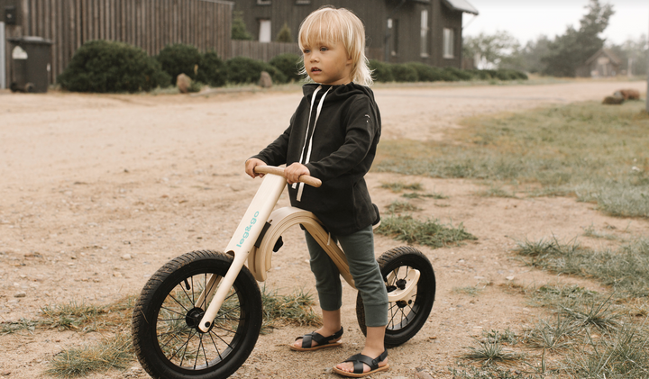 Toddler Playing With A Balance Bike